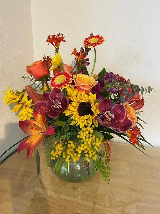 Mixed bouquet of bright flowers in a glass vase