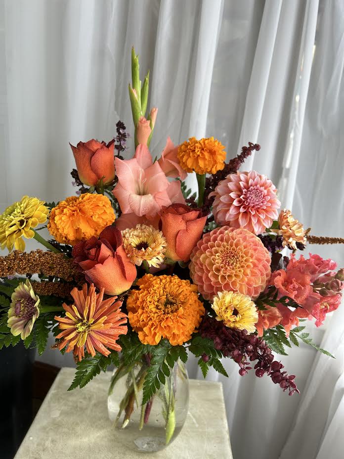 August Sunrise - Artful and elegant; a clear glass bowl gathers the best of a warm color palette.