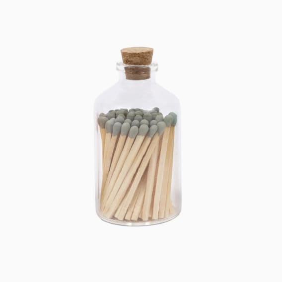 Glass bottle filled with wooden matches and sealed with a cork lid