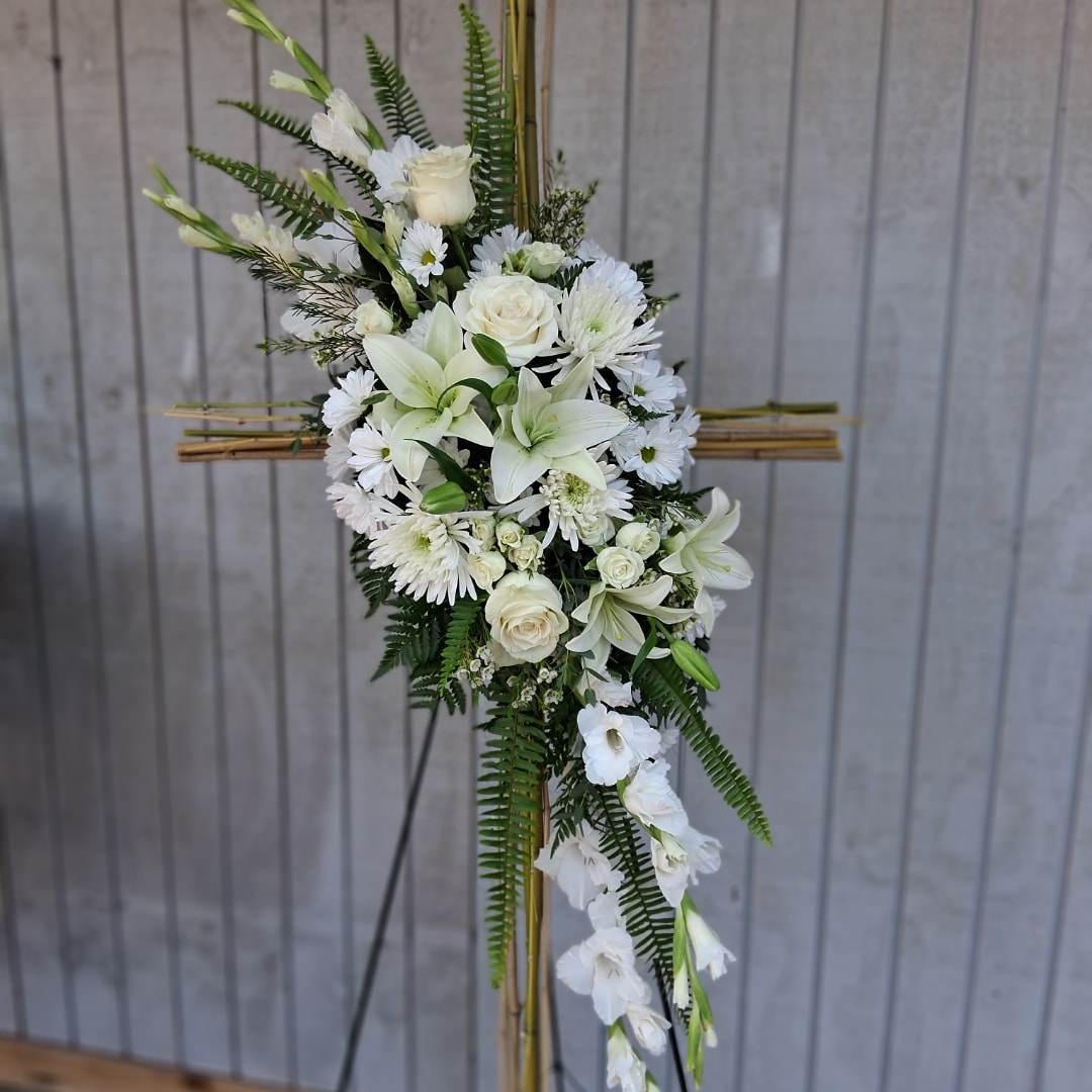 White floral standing spray on a bamboo easel