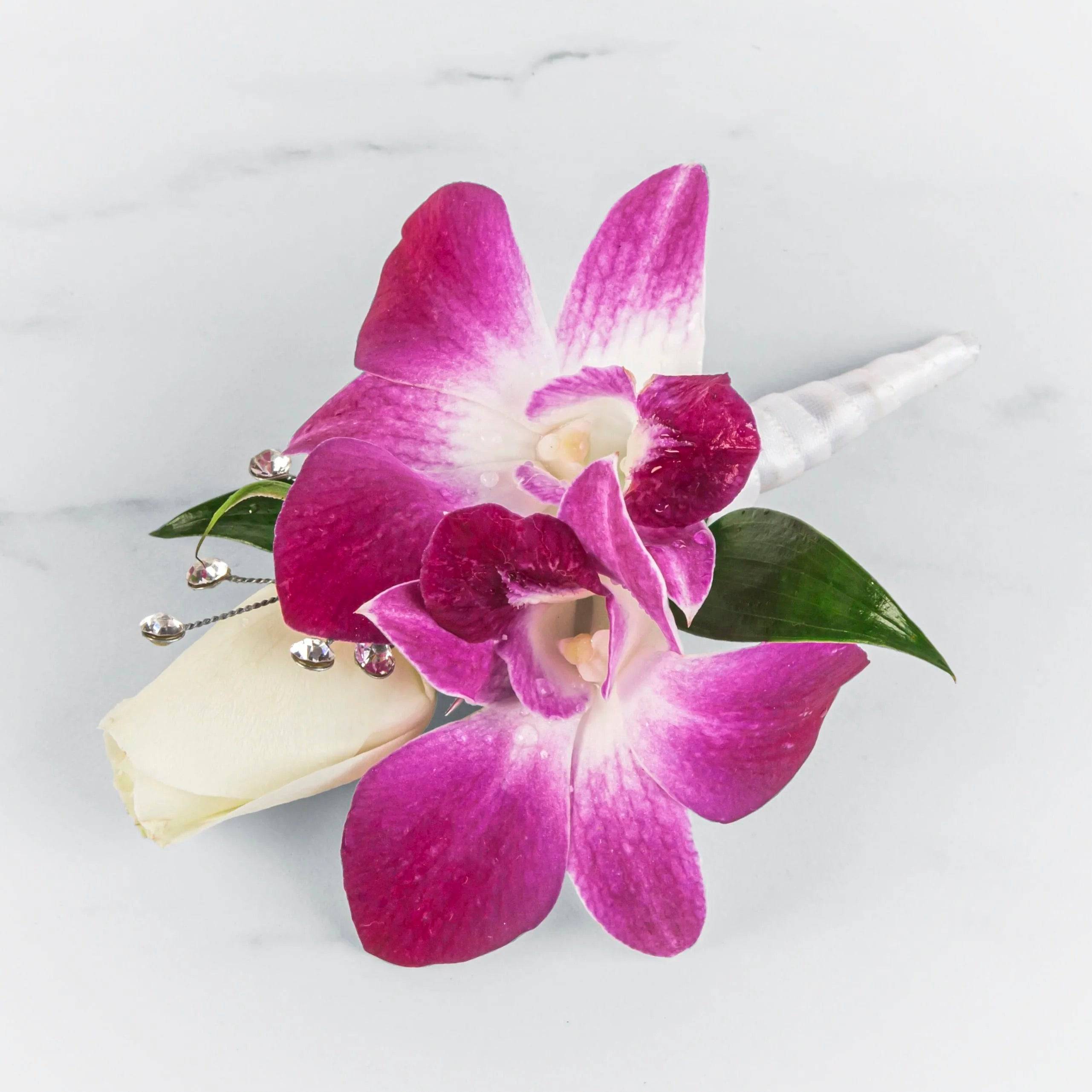 Pink orchid boutonniere with a white rose bud and crystal accents