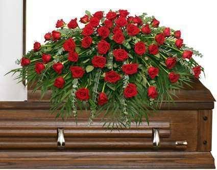 Red rose casket spray on a wooden casket