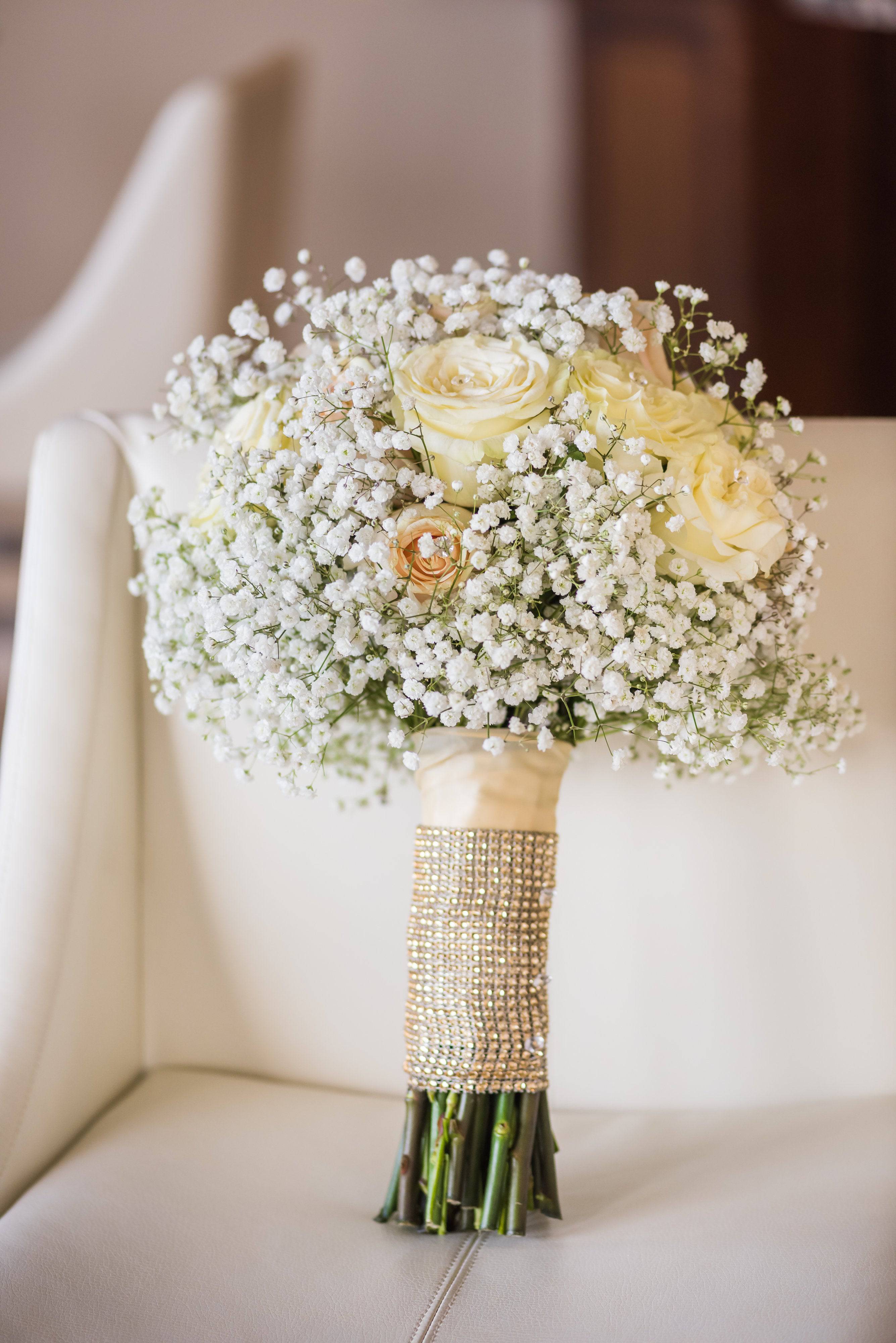 White rose bouquet with baby's breath and a jeweled handle wrap