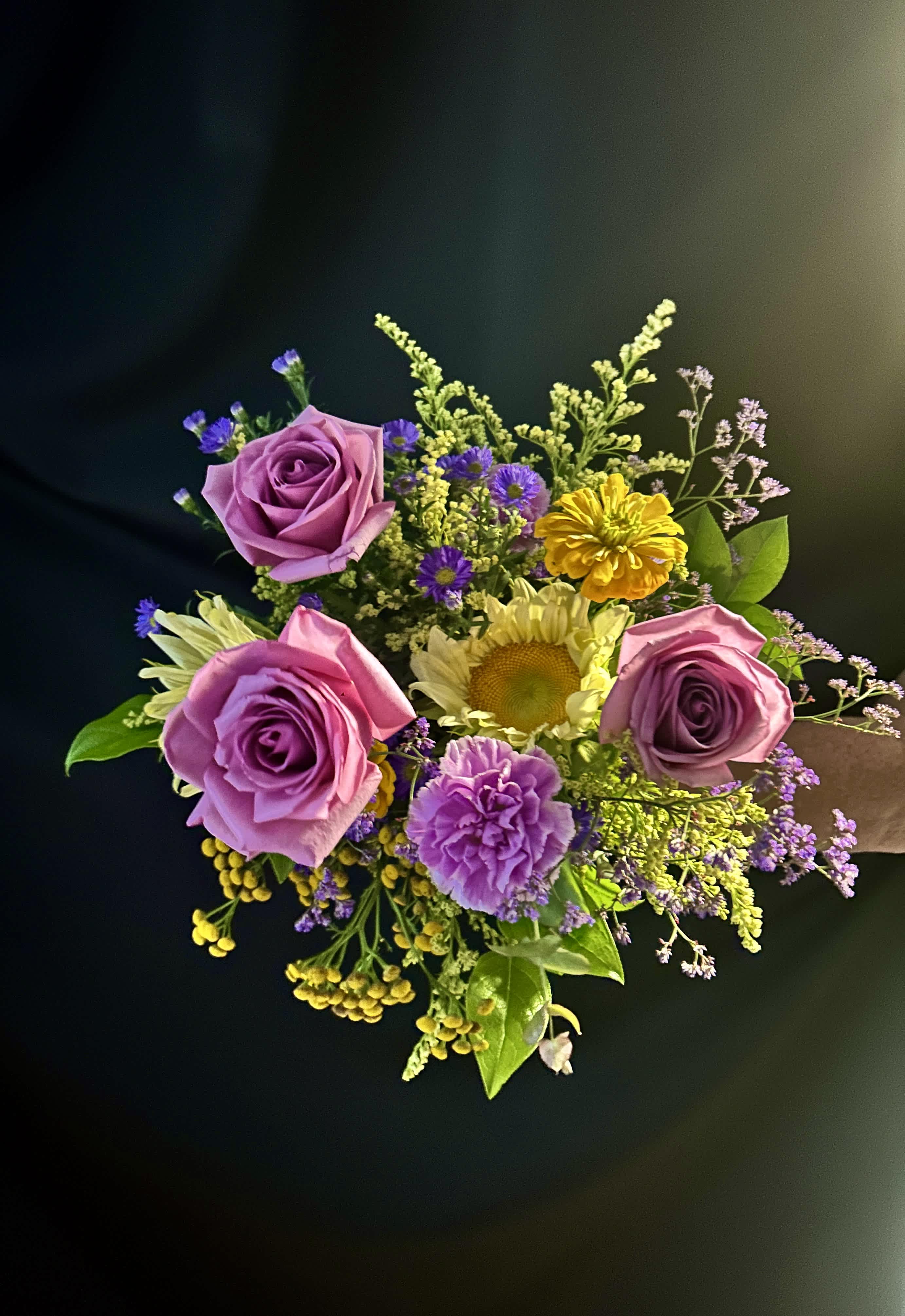 Bouquet of pink and purple roses with yellow and lavender accent flowers