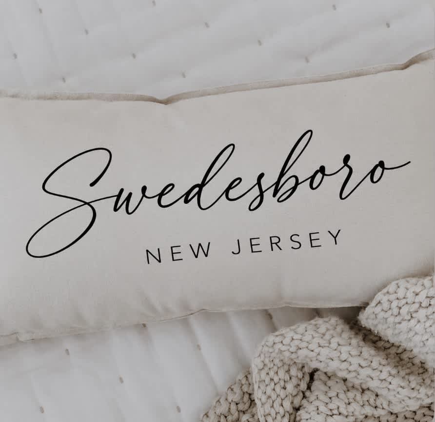 Cream pillow with the word "Swedesboro" printed on it