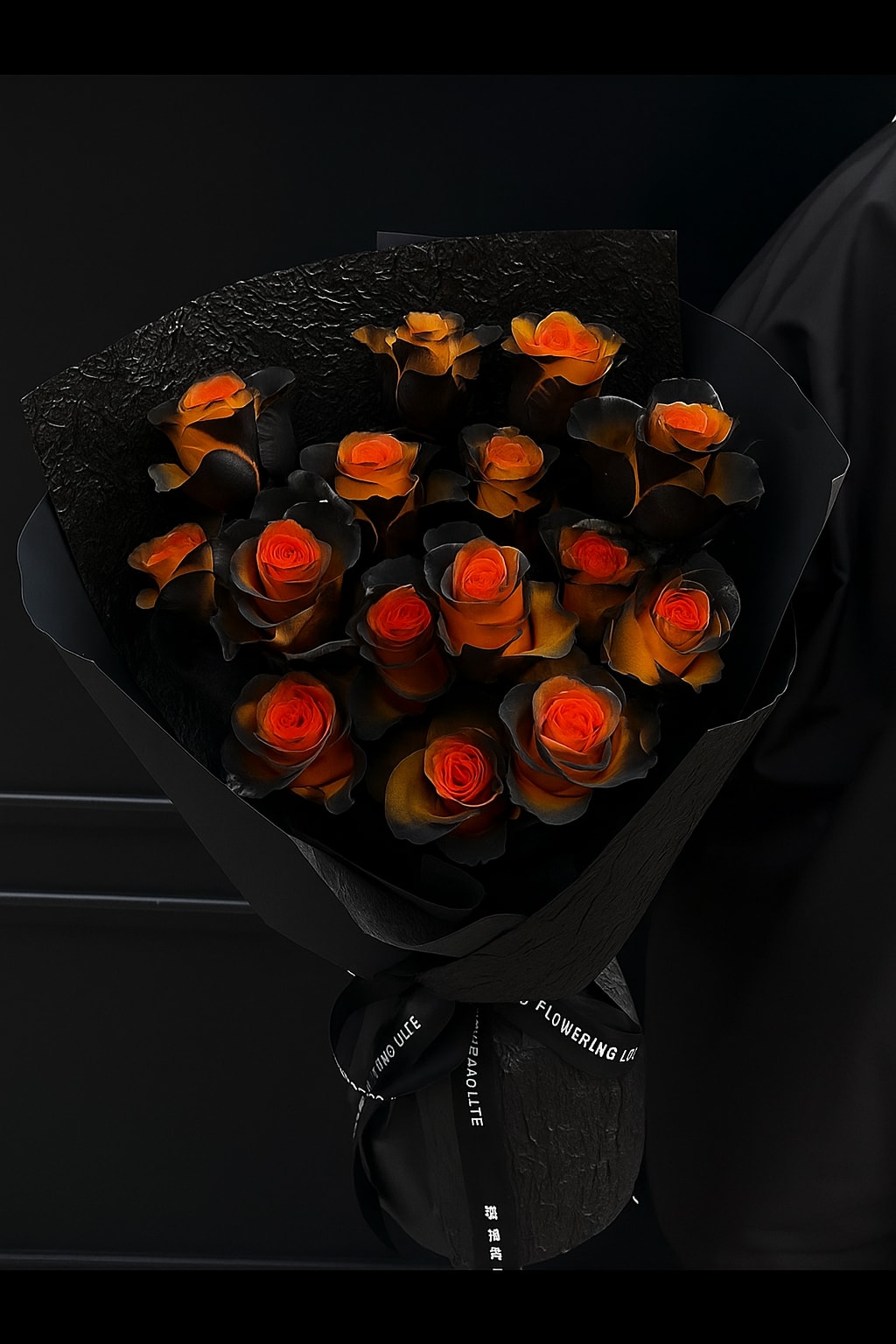 Bouquet of orange roses wrapped in black paper