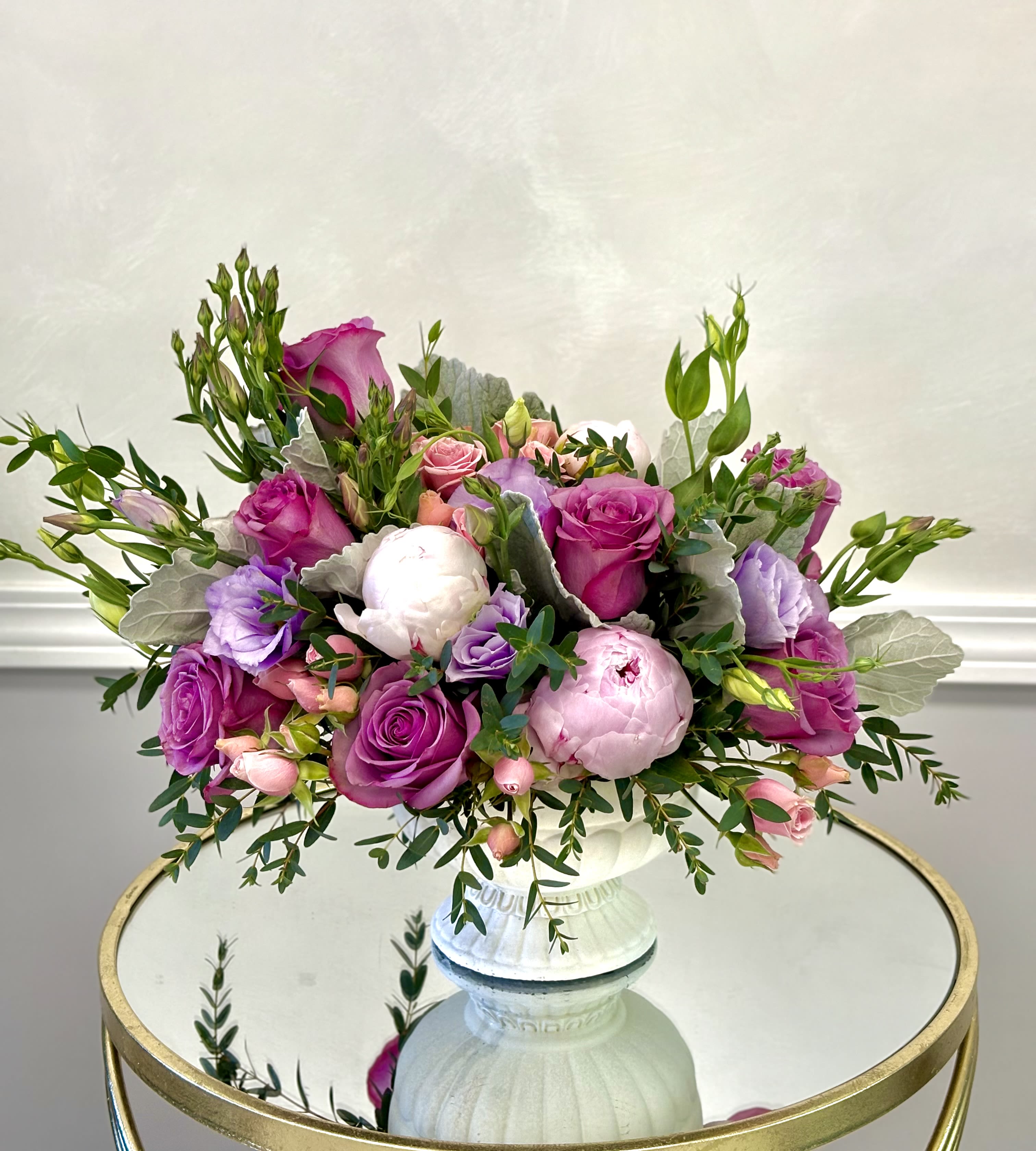 Peony Rose Elegance By VLM Flowers - A full, low-spreading bouquet of lavender roses and pale peonies creates a soft, romantic centerpiece-perfect as a birthday bouquet, anniversary roses alternative, or a thoughtful thank-you arrangement. The mix of roses, peonies, and lisianthus gives a layered, garden-fresh look that will make the person you're thinking of feel cherished and noticed without feeling over-the-top.