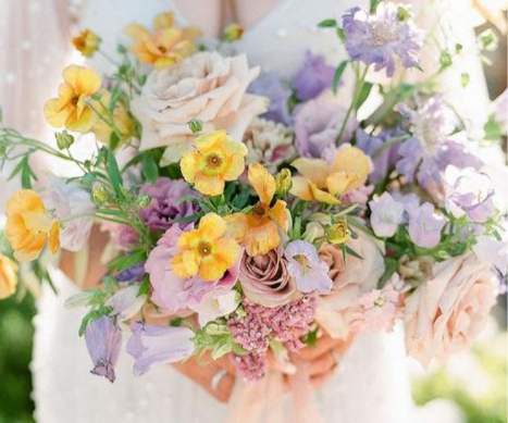 Pastel bouquet with roses and small yellow and lavender flowers