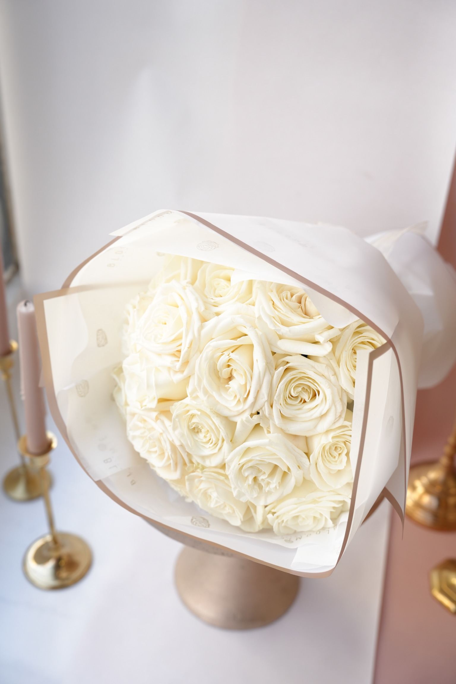 Bouquet of cream roses wrapped in white paper
