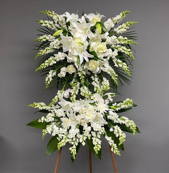 White floral standing spray on an easel