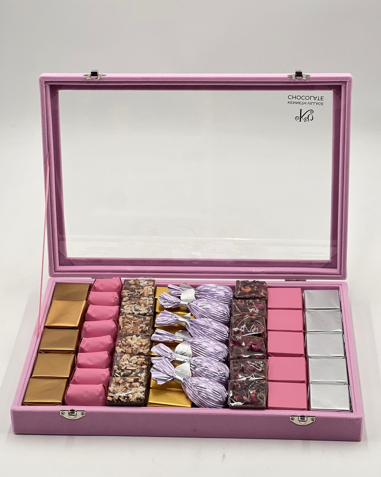 Pink gift box with assorted wrapped chocolates and candies