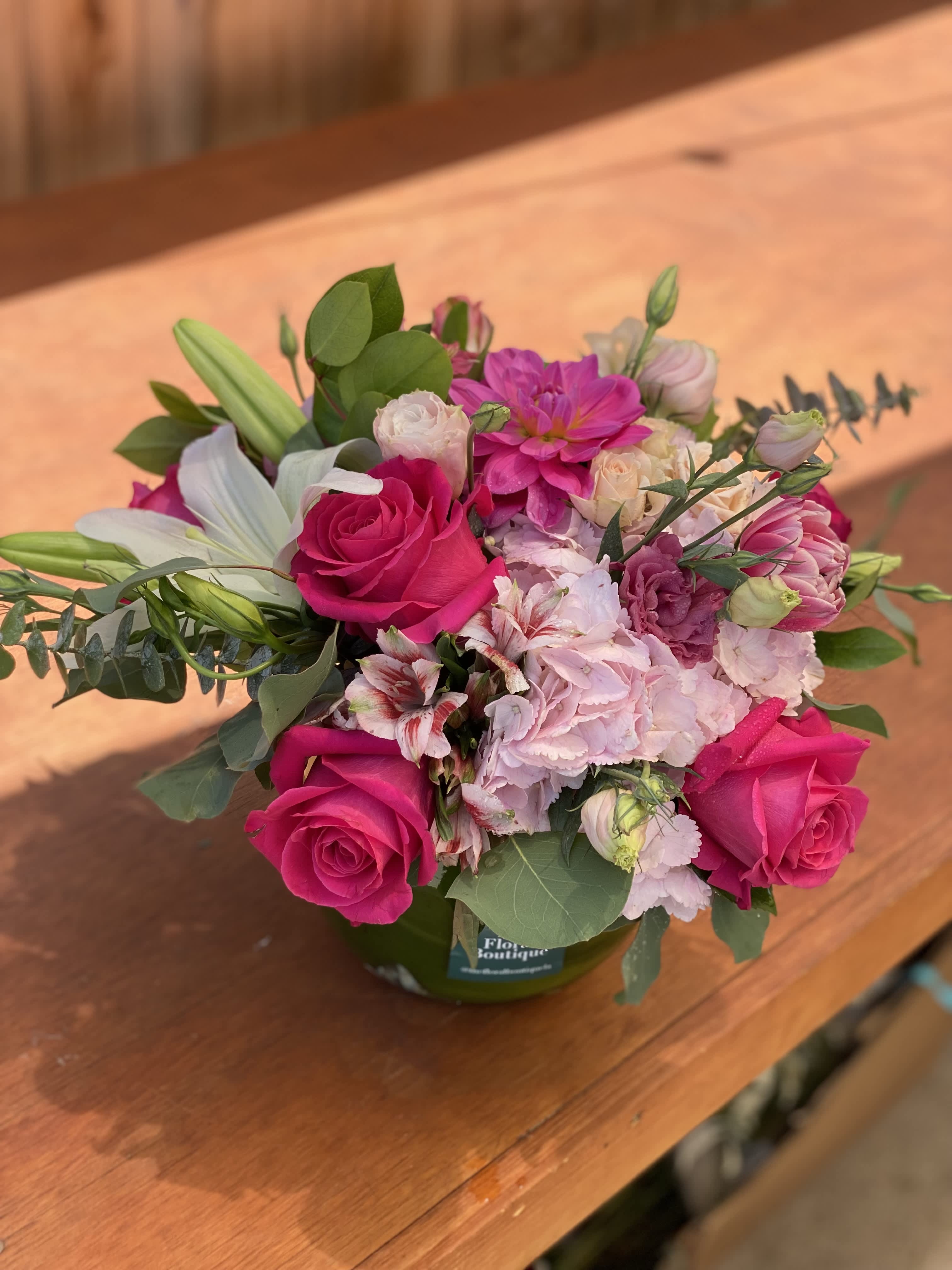 Pink and white mixed bouquet in a green vase