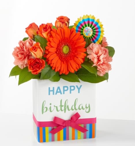 Birthday flower arrangement in a gift box with orange and pink blooms