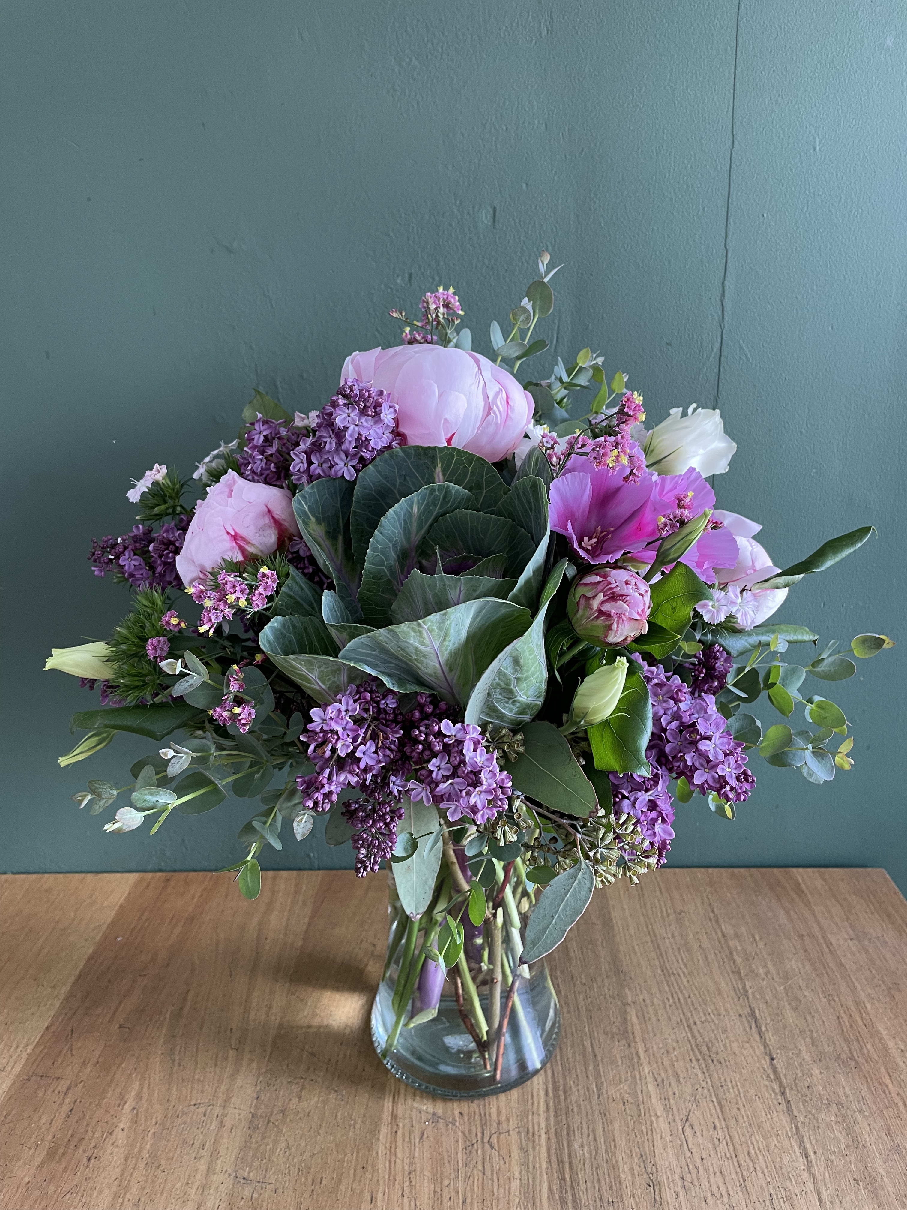 Pink and purple mixed bouquet in a clear glass vase
