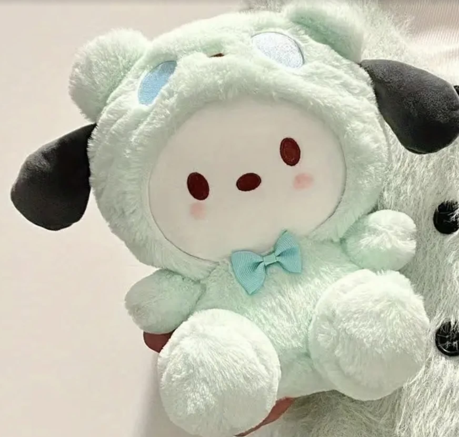 Mint plush sheep toy with a blue bow