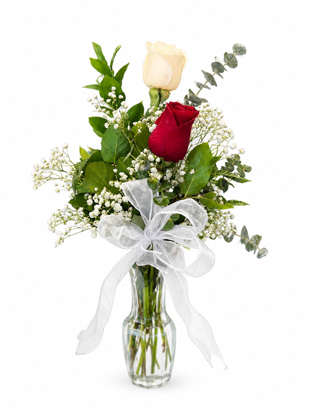 Red and white roses in a clear glass vase with a white ribbon