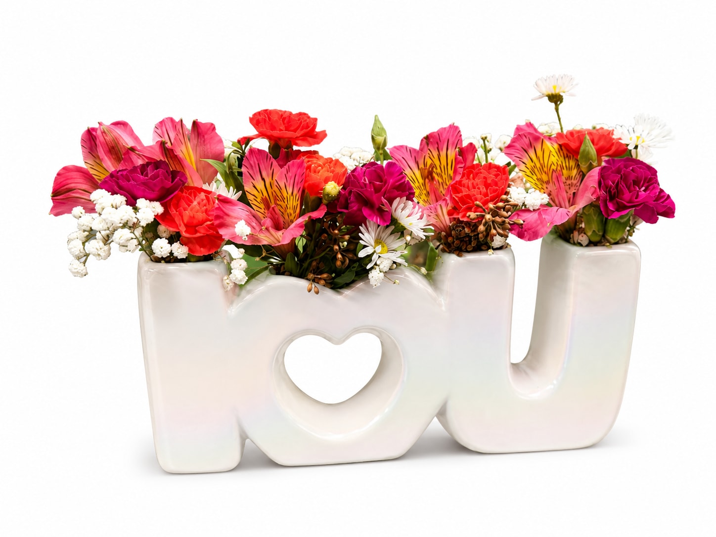Colorful mixed flowers arranged in a white "MOM" vase with a heart cutout