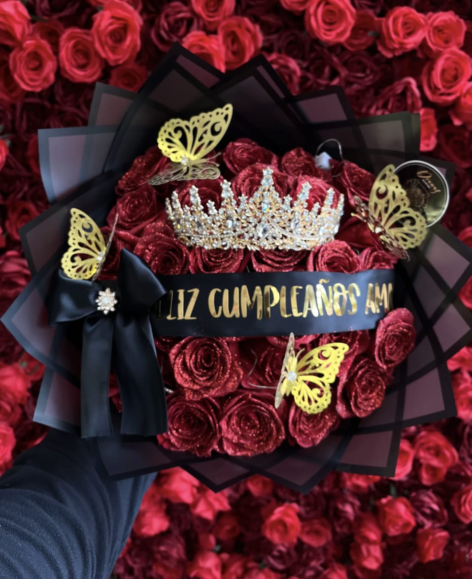 Bouquet of red roses with a jeweled crown and black ribbon