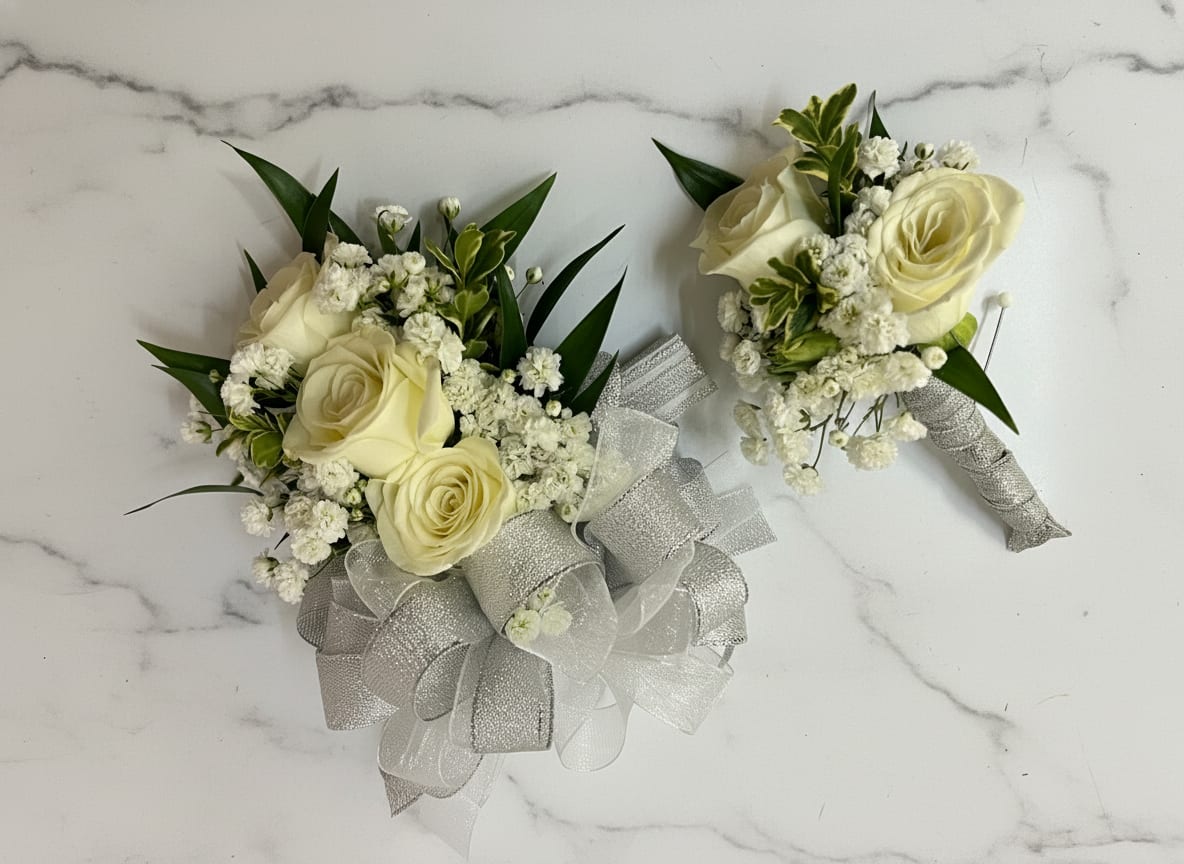Traditional Corsage &amp; Boutonnière  - White rose corsage and boutonniere set accented with baby’s breath for a soft, classic look. The corsage comes on an adjustable wristlet, and the boutonniere is attached with a magnet for easy wear. Ribbon color is customizable, please add your choice in the special instructions.
