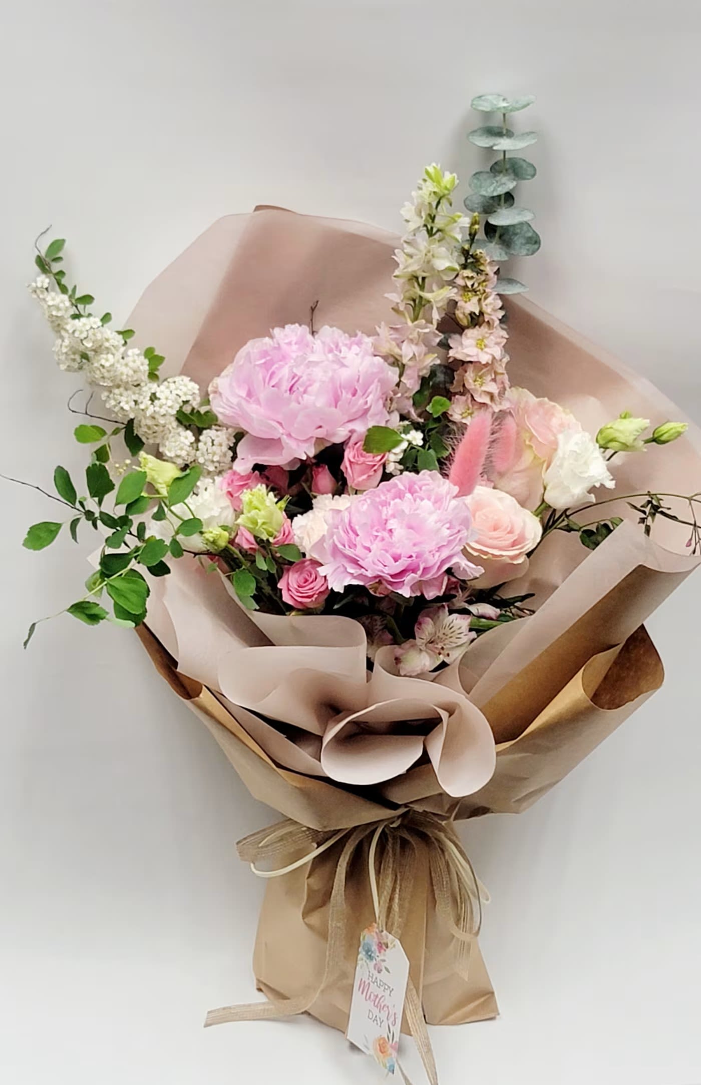 Pink Poetry - Peonies, Roses, Snapdragons, Greens with decorative color wrapping with ribbon Cut flowers with Crafted decorated Wrapping. Flowers that are high quality, fresh, and beautiful. While we may seasonally need to substitute for flower variety also we may sometimes need to use a different greens for sub material.