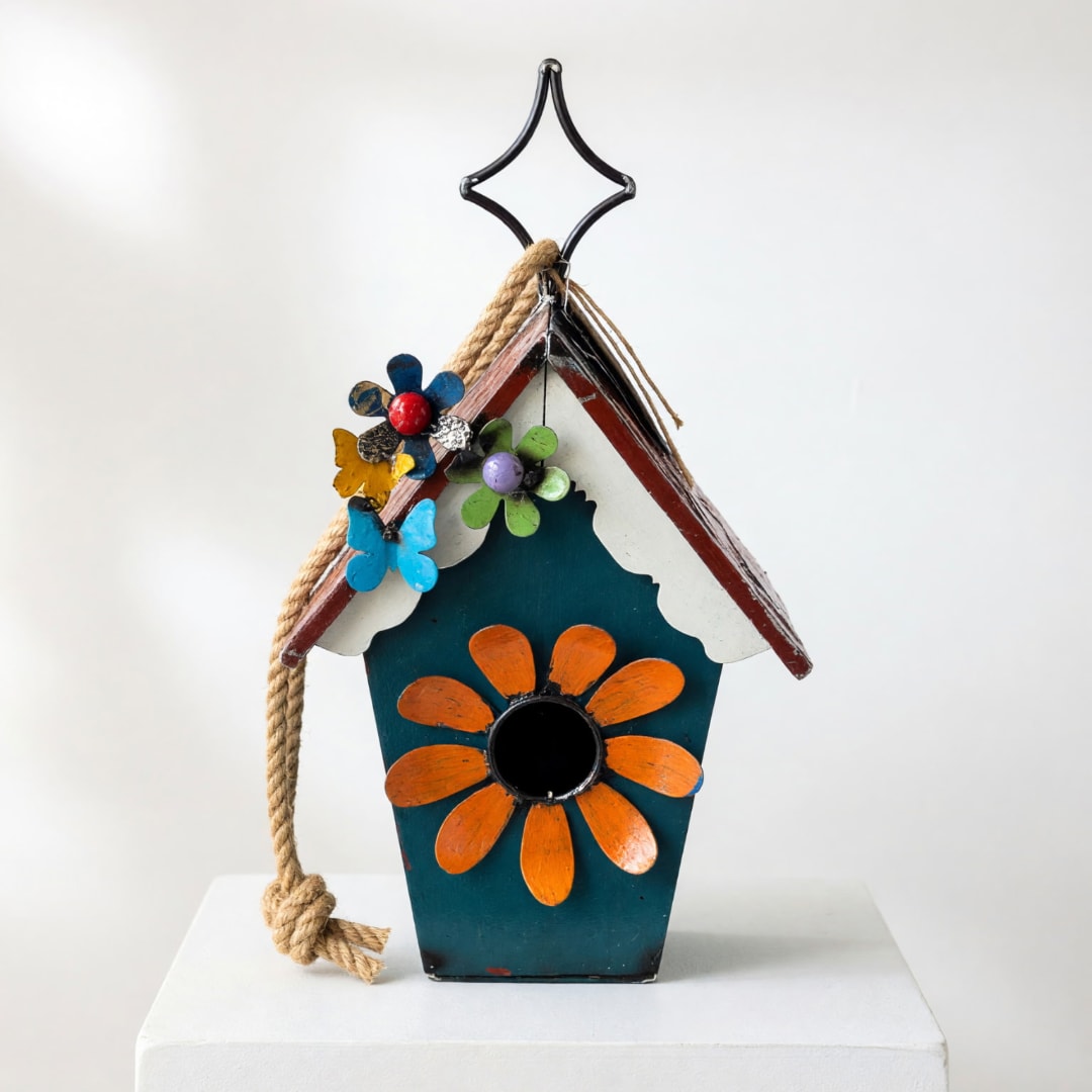 Decorative birdhouse with painted flowers and a rope hanger