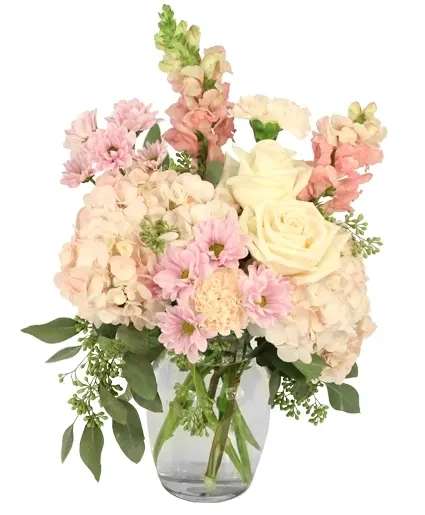 Prim &amp; Proper Pastels Flower Arrangement - Celebrate love with this enchanting arrangement of soft pastels, featuring hydrangeas, roses, daisies, poms, and snapdragons. The gentle hues create a romantic and elegant display for any occasion, making a perfect way to express your love. Order Prim &amp; Proper Pastels today and make this year the best yet.  Includes: Medium Ginger Vase, Greens: Seeded Eucalyptus , Peach Carnations, Pink Hydrangeas, Lavender Daisy Poms, White Roses, Pink Snapdragons.