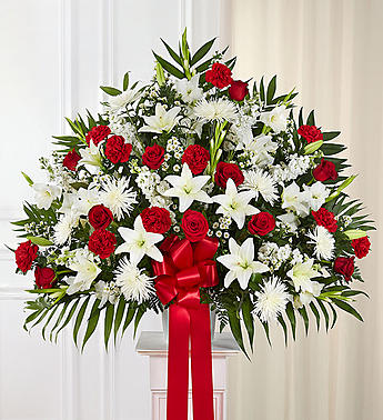Large red and white floral spray with a red ribbon bow