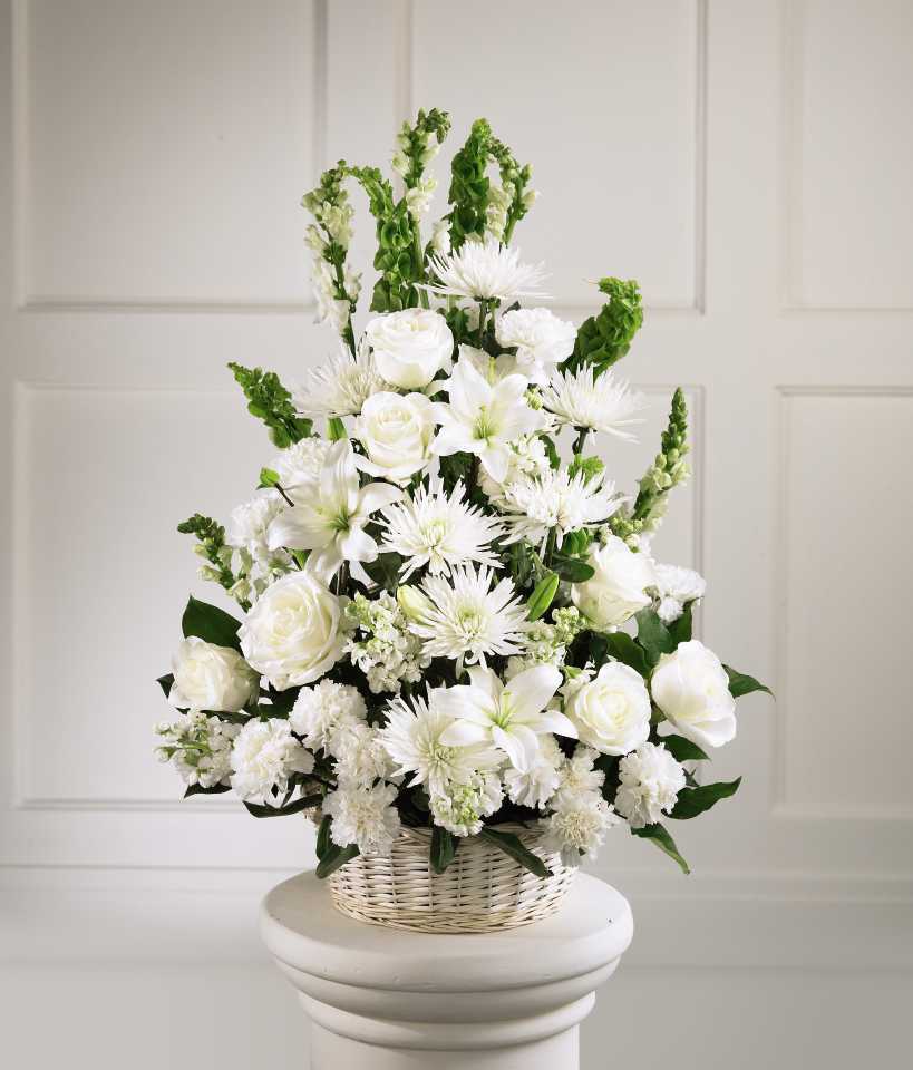 White floral arrangement in a wicker basket