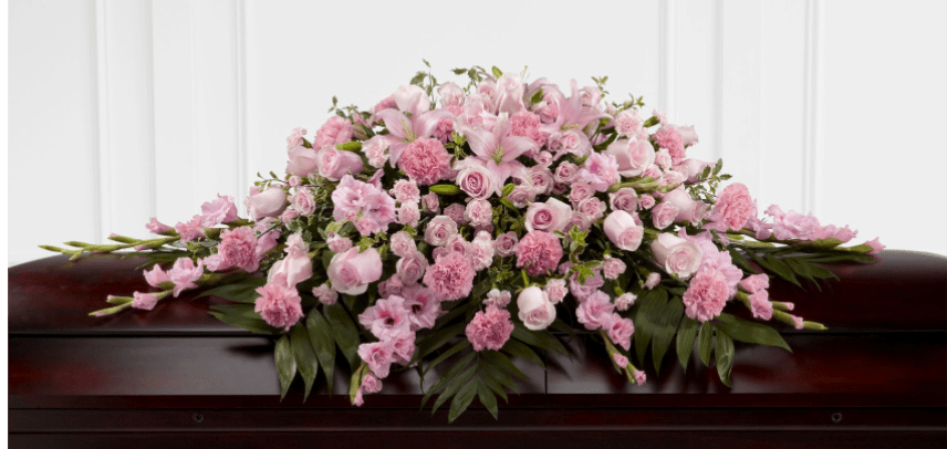 Pink floral casket spray with roses, lilies, and carnations