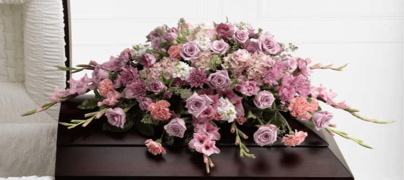 Lavender and pink floral casket spray with roses and carnations