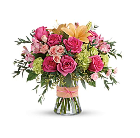 Pink rose bouquet with lilies in a glass vase