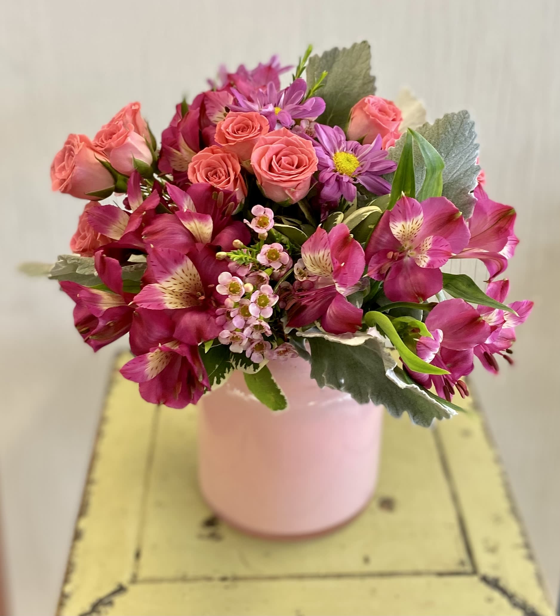 Pink and magenta bouquet in a pale pink vase
