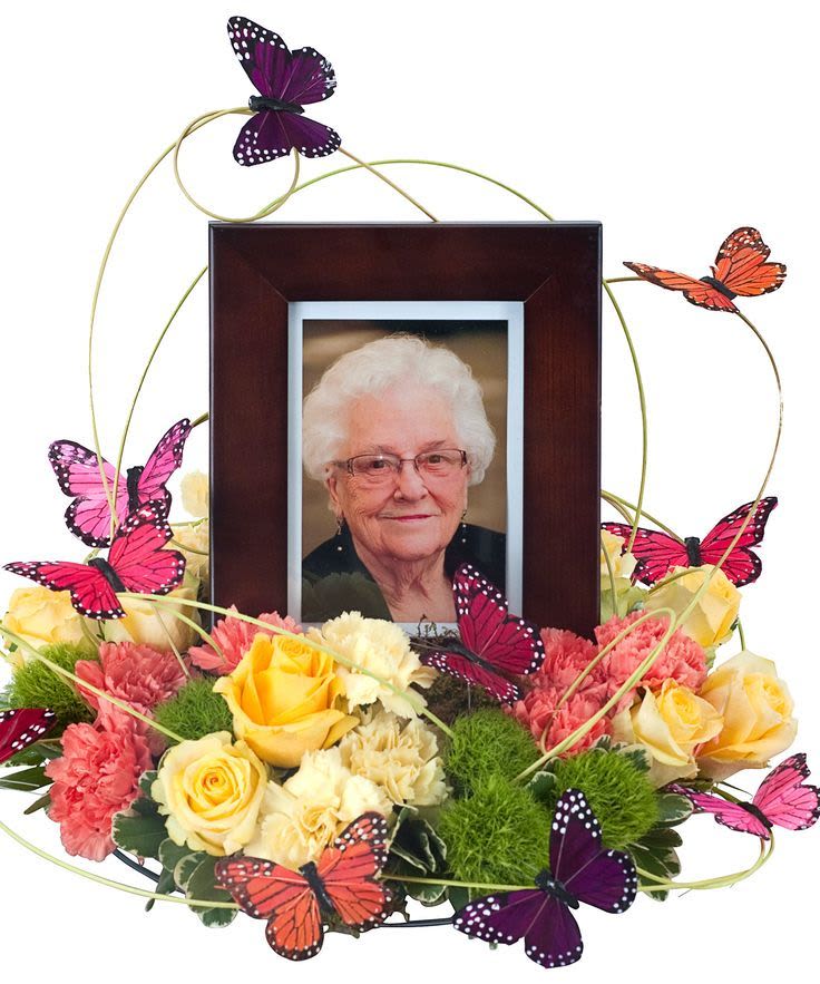 Floral photo frame arrangement with yellow and pink roses and butterfly accents