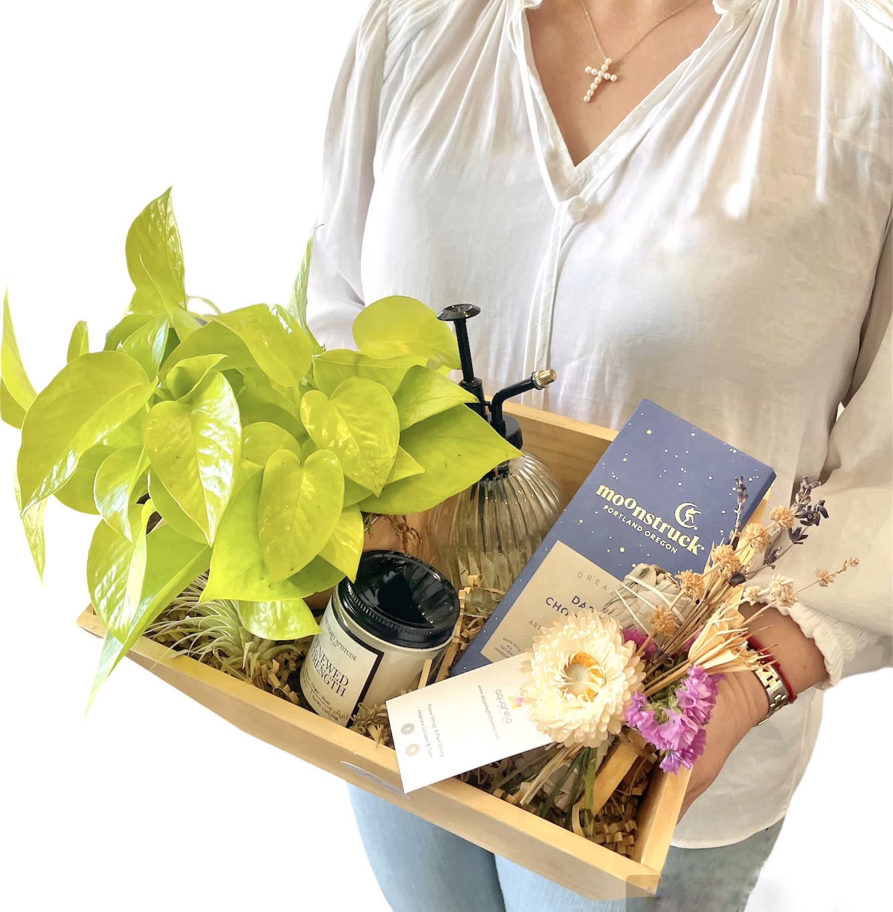 Gift tray with a potted plant, candle, dried flowers, and a chocolate bar