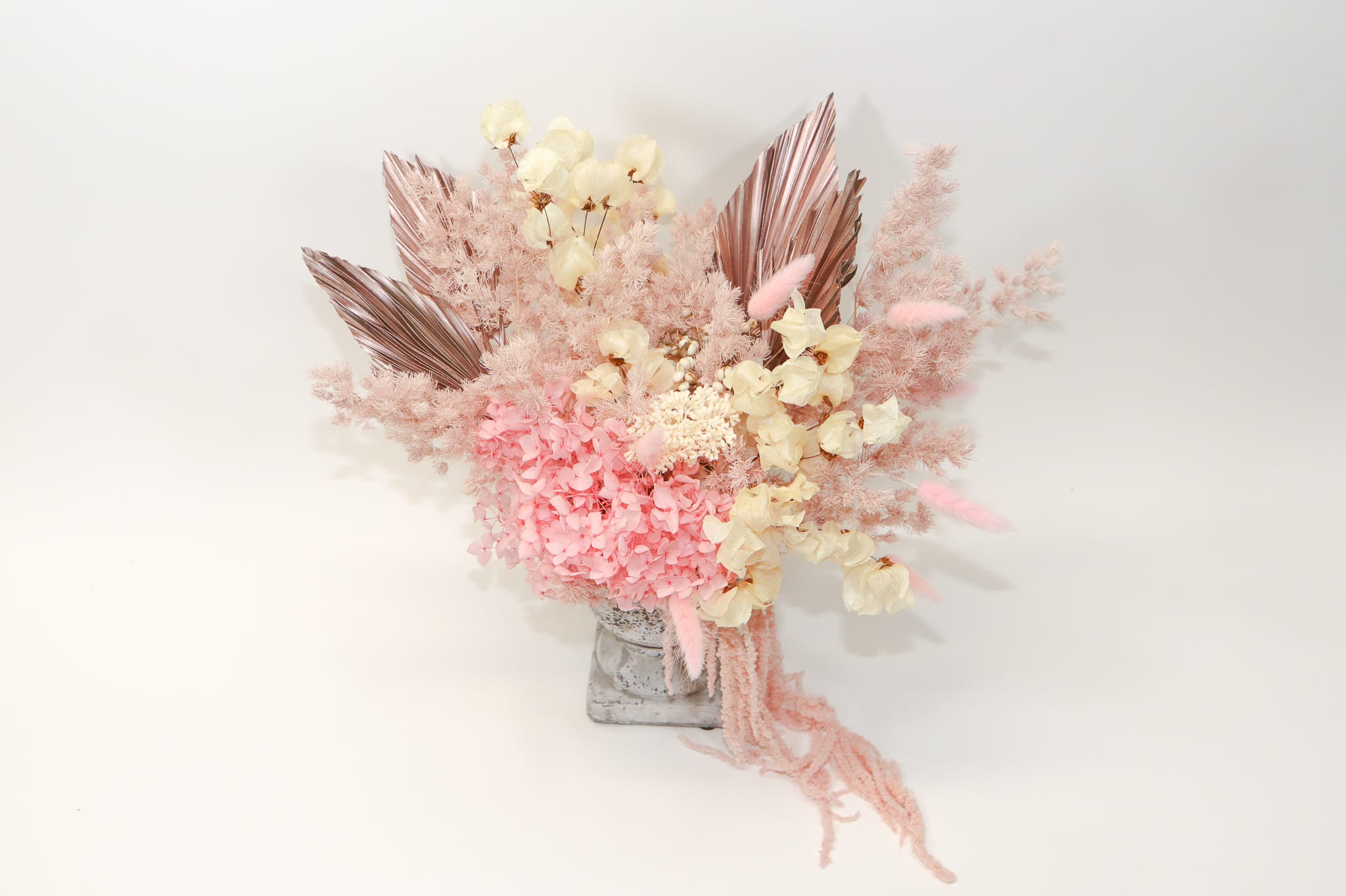 Pink and cream dried floral arrangement in a gray vase