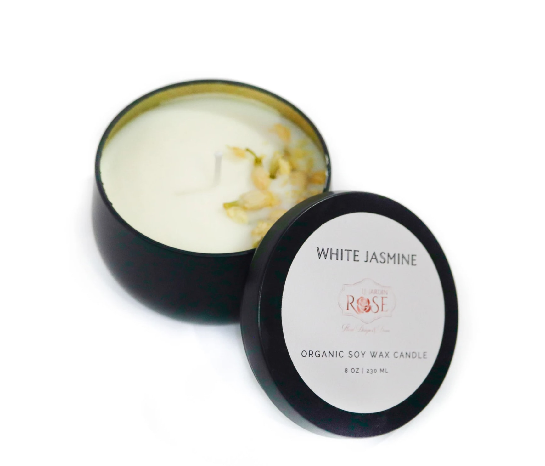 Open black candle tin with white jasmine wax and lid beside it