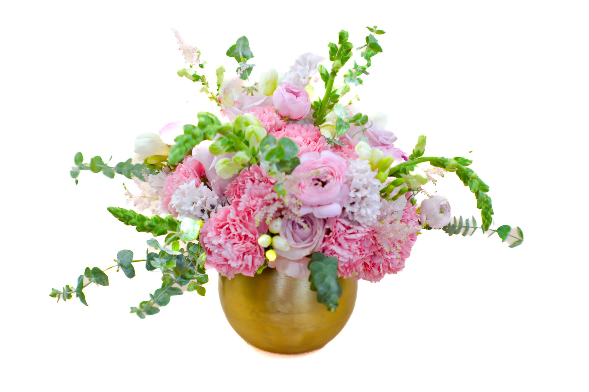 Pink and white floral arrangement in a gold vase