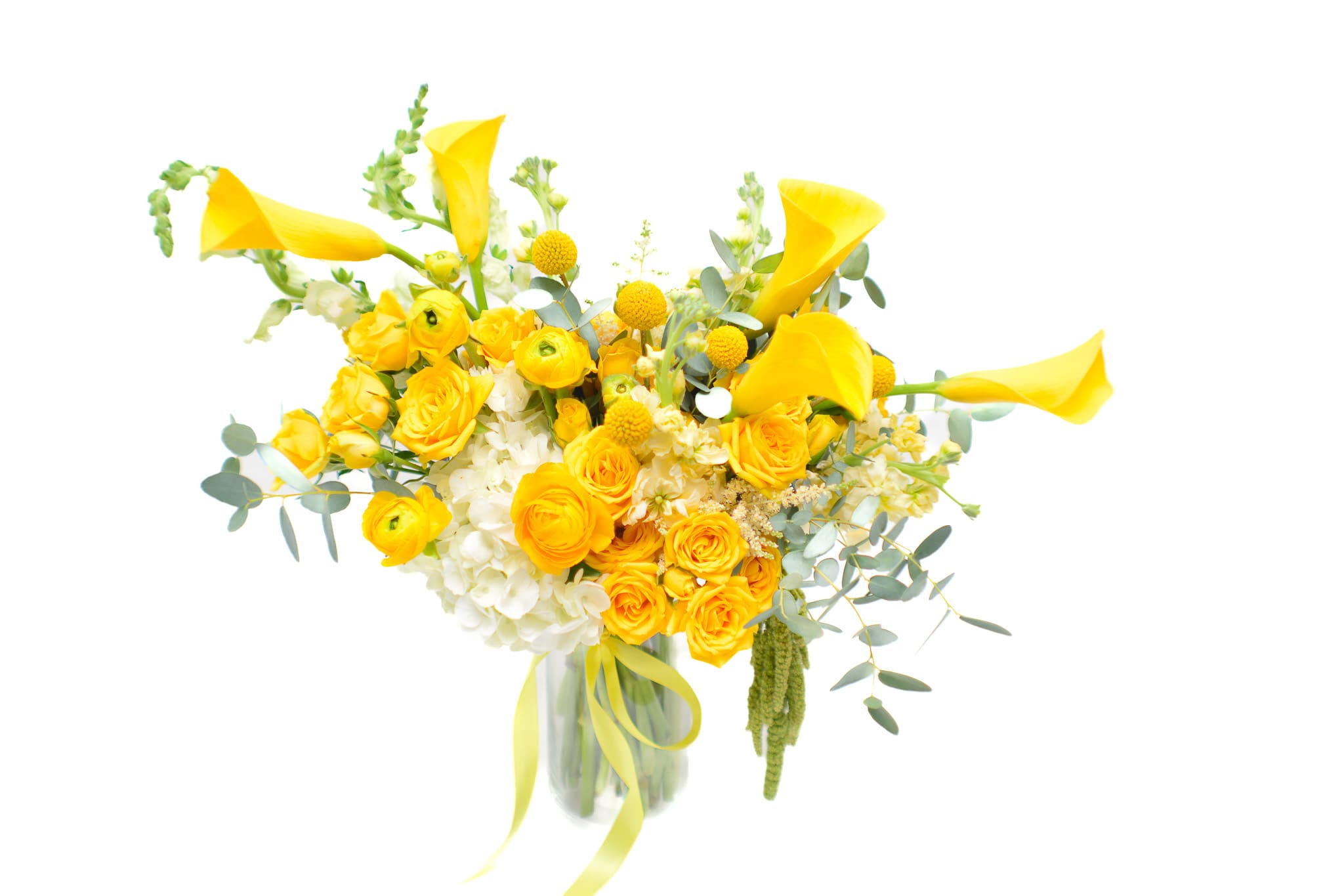 Sunshine - Just in time to celebrate summer, Sunshine honors the beauty and warmth of the season with a bevy of fresh, cool hues. Brilliant callas steal the show and brighten the room with undeniable feel-good vibes. Look closely and you'll find delightful ranunculus to bring some added texture to the arrangement. What better way to usher in the sunniest time of the year? Yellow flowers represent joy and lightheartedness. They are also a symbol of friendship, new beginnings, and happiness. 