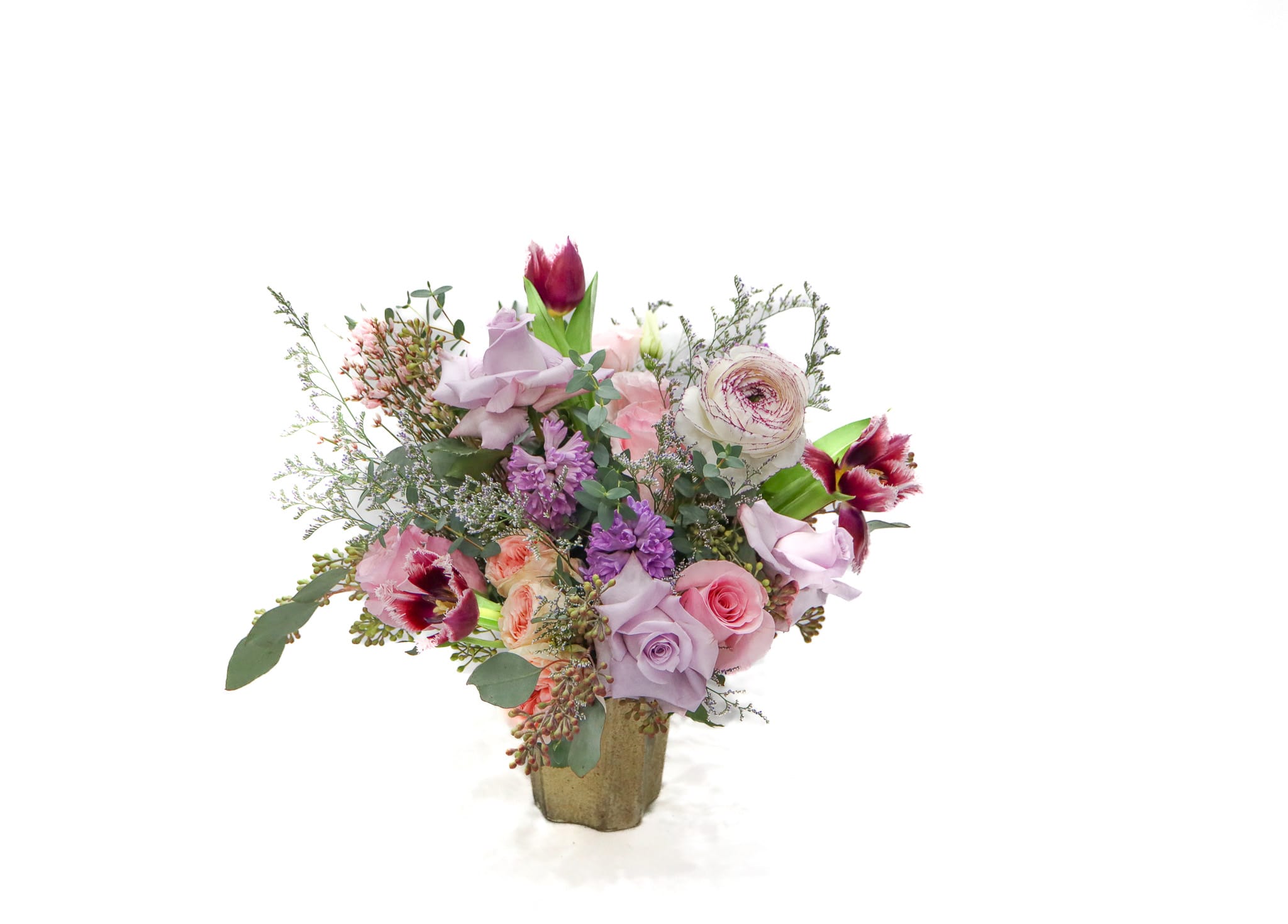 Bouquet of pink and lavender flowers in a gold vase