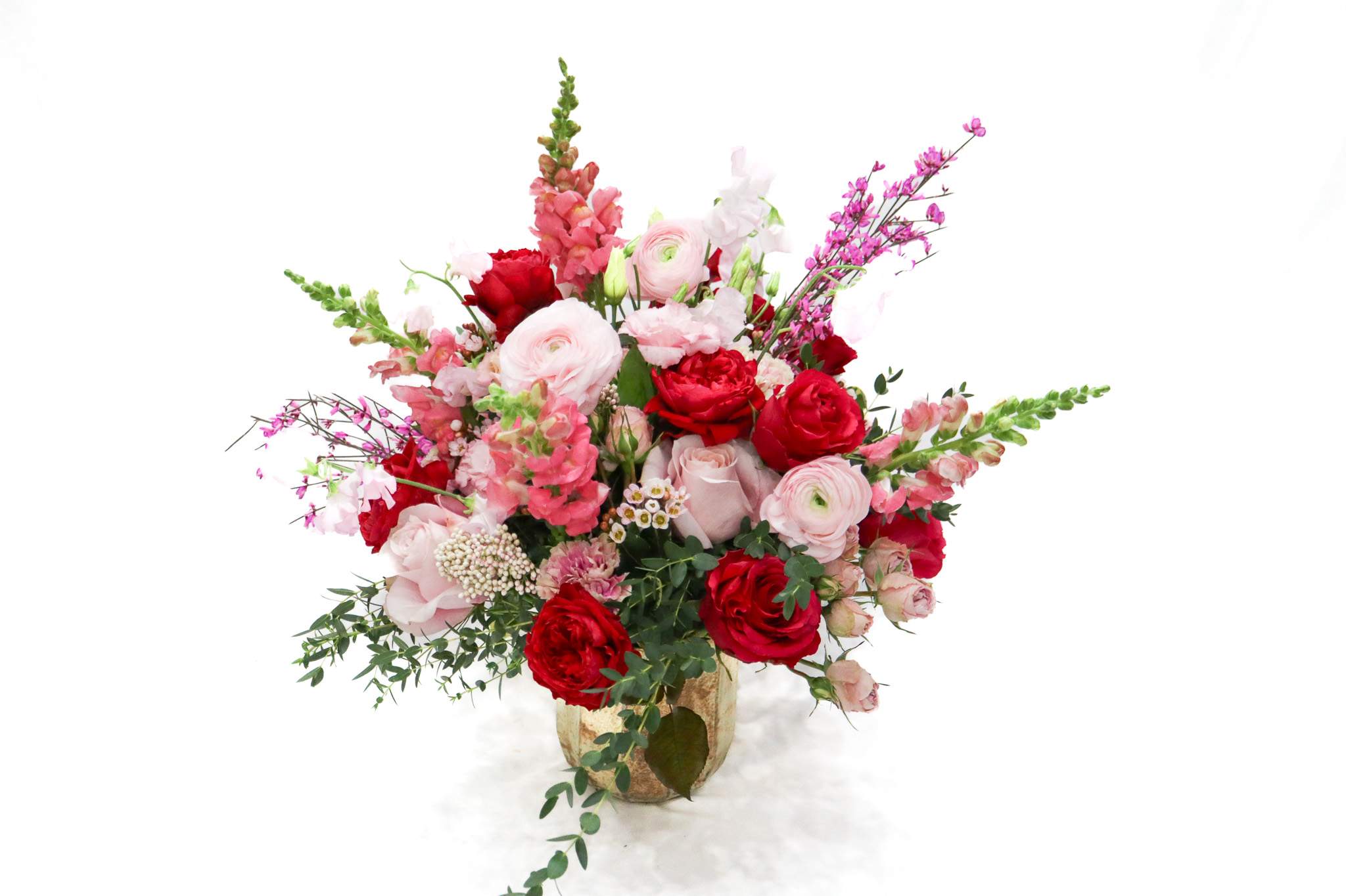 Pink and red mixed flower arrangement in a vase