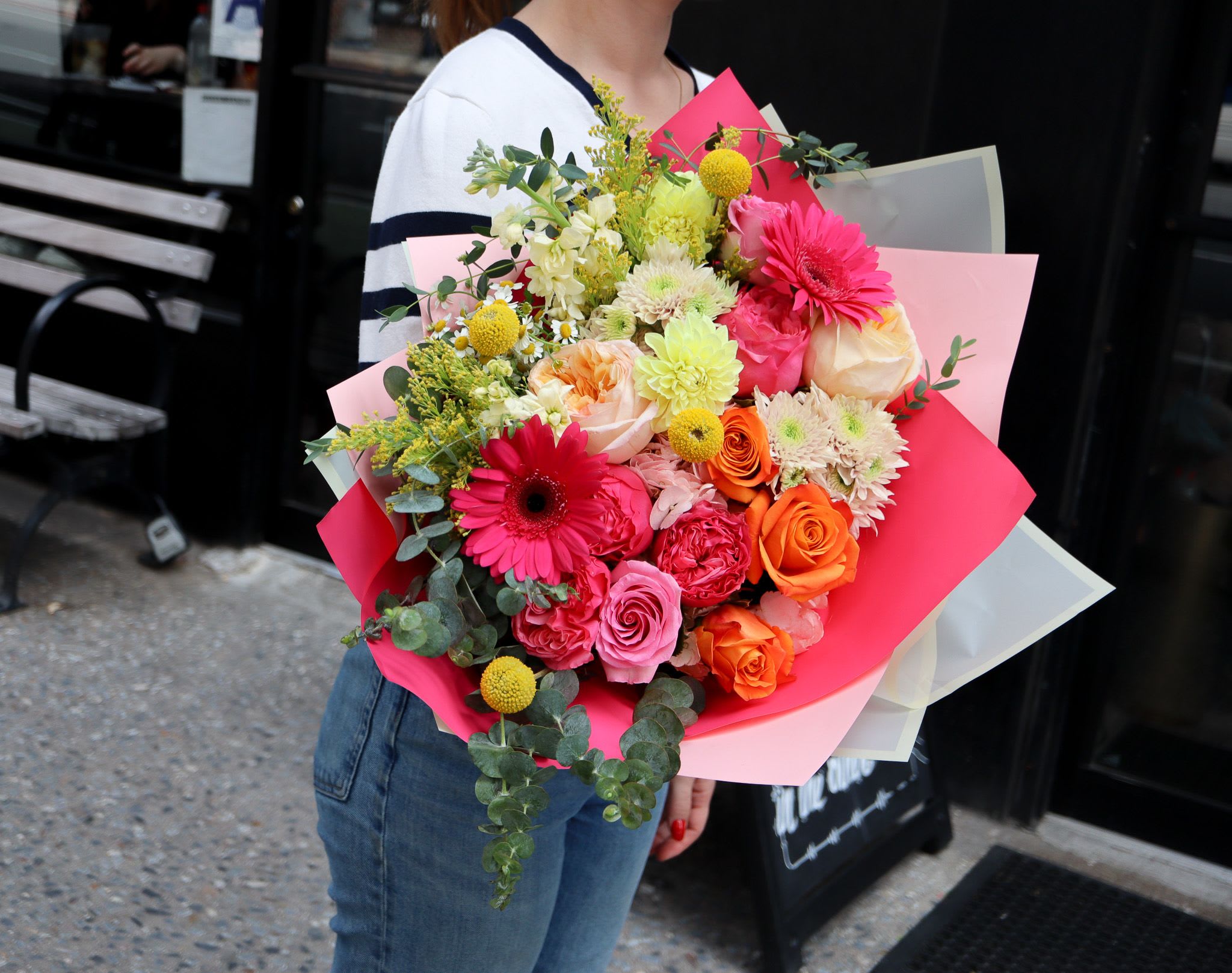 Summer Fling  - Summer Fling Bursting with bold pinks, fiery oranges, and pops of sunny yellow, Summer Fling is a fun and flirty hand bouquet that captures the heat and energy of the season. Featuring roses, gerberas, and playful textures, it’s perfect for brightening someone’s day — or your own! Note: This bouquet does not come in a vase. 