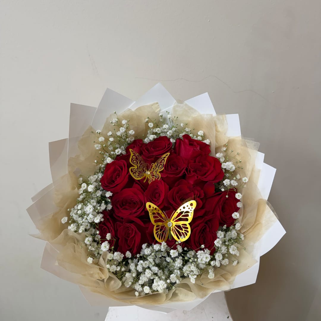 Bouquet of red roses with white baby's breath and butterfly picks