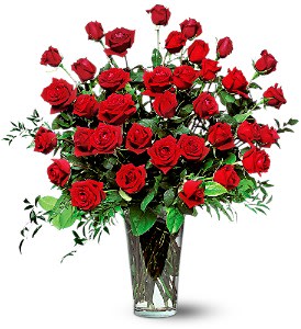 Red roses arranged in a clear glass vase
