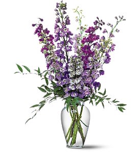 Purple mixed flowers in a clear glass vase