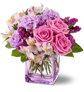 Pink and lavender bouquet in a square glass vase