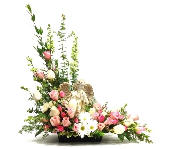 Sympathy arrangement of pink and white roses with a central angel figurine in a low black container