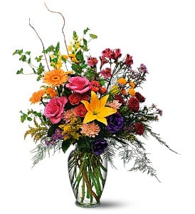 Colorful mixed flower arrangement in a clear glass vase