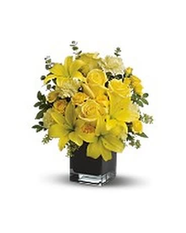 Yellow floral arrangement in a black square vase