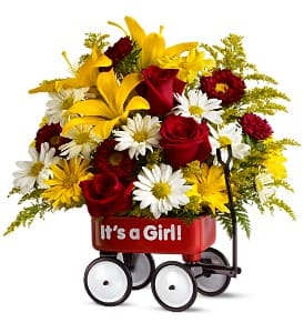 Bouquet of red roses, white daisies, and yellow lilies in a red wagon