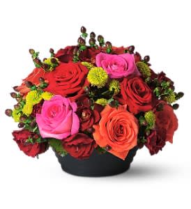 Bouquet of red, pink, and orange roses in a black container